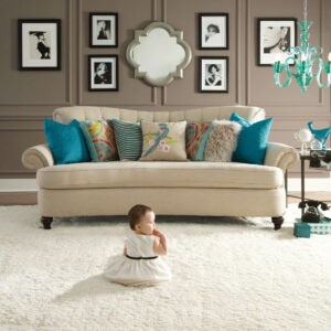 Cute baby sitting on carpet floor | Right Carpet & Interiors