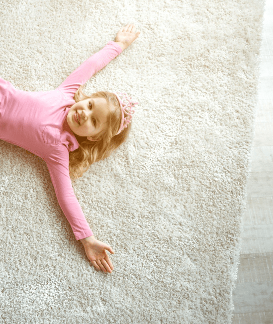 Cute girl laying on rug | Right Carpet & Interiors